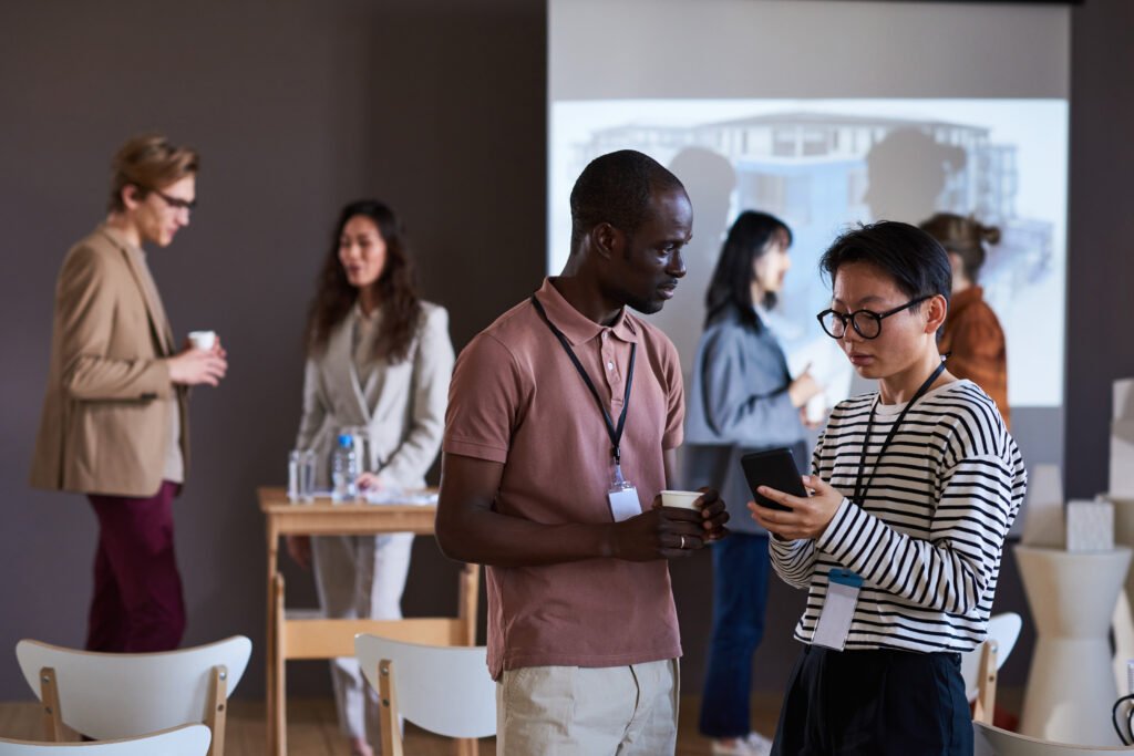 Colleagues talking to each other at the AI Summit 